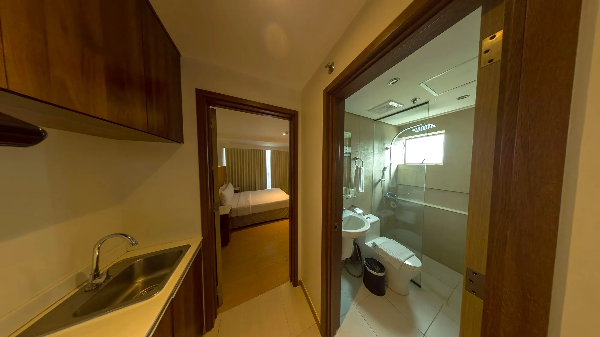 One Bedroom Standard Room bathroom with a glass shower, beside the bedroom
