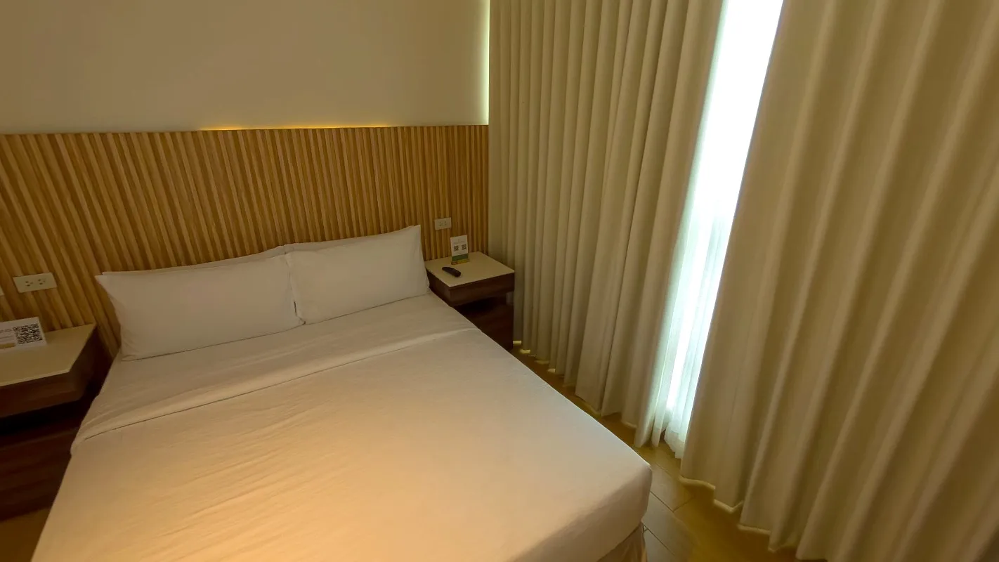 Studio Standard Double Room queen bed beside a curtained window