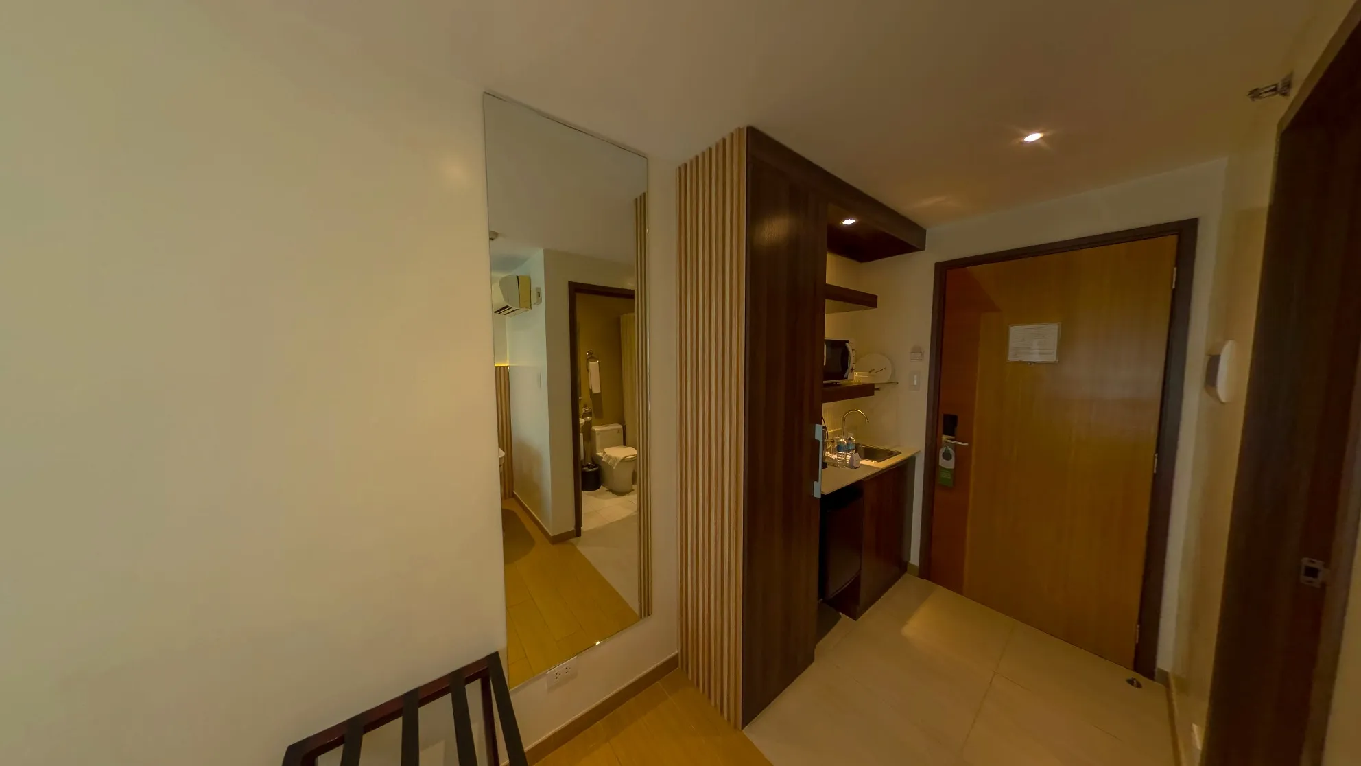 Studio Twin Room entry with a mirrored wardrobe and kitchenette