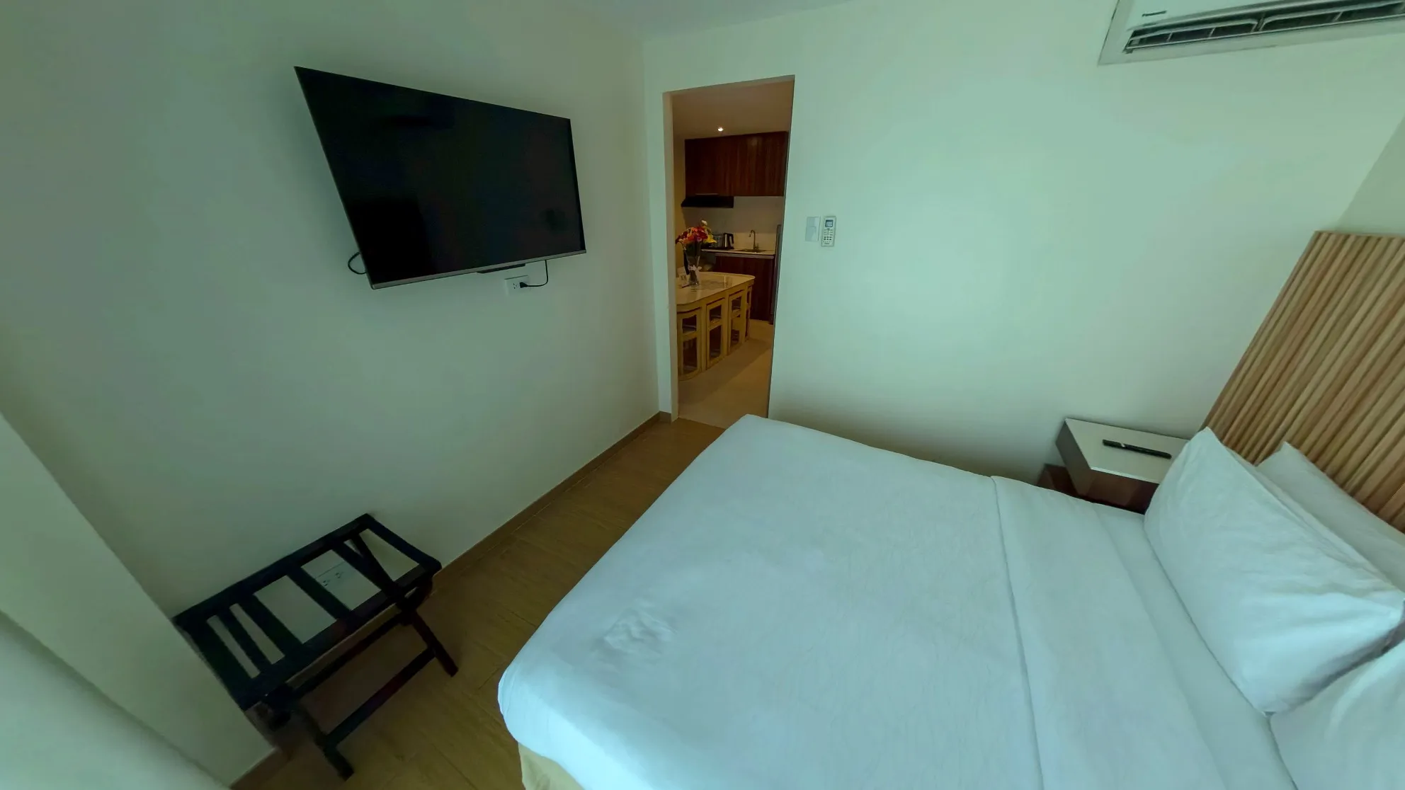 Two Bedroom Standard Room bedroom with a queen bed and wall-mounted TV